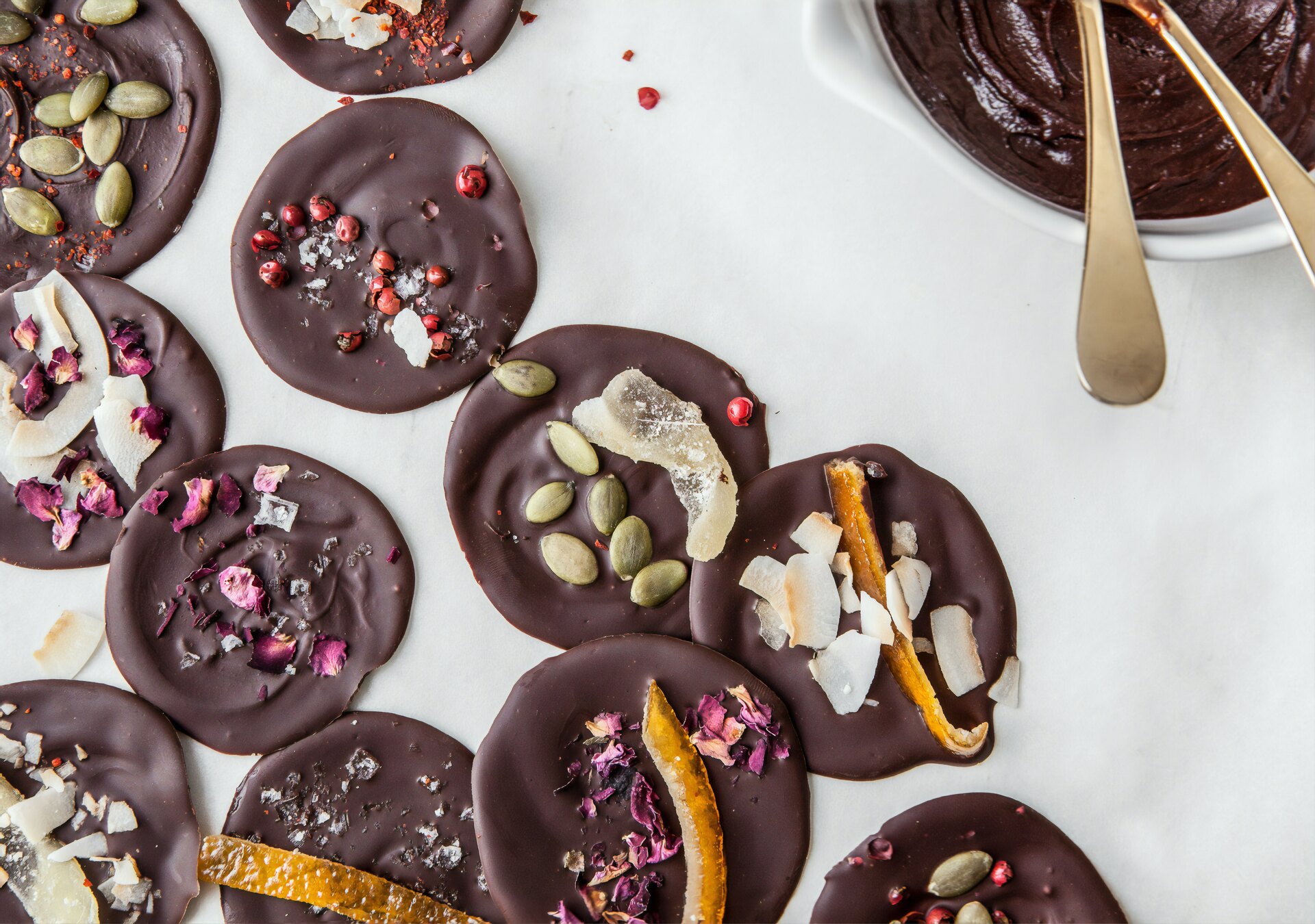 A tempting assortment of gourmet chocolates in various shapes and flavors.